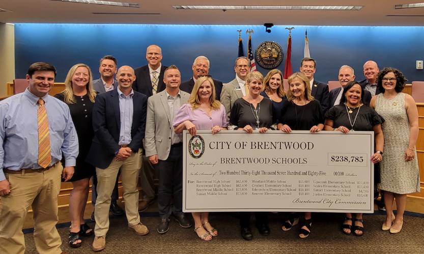 group of people holding oversized check